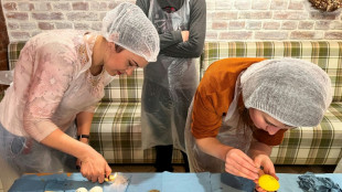 Displaced Ukrainians adorn Easter eggs for soldiers on the front 