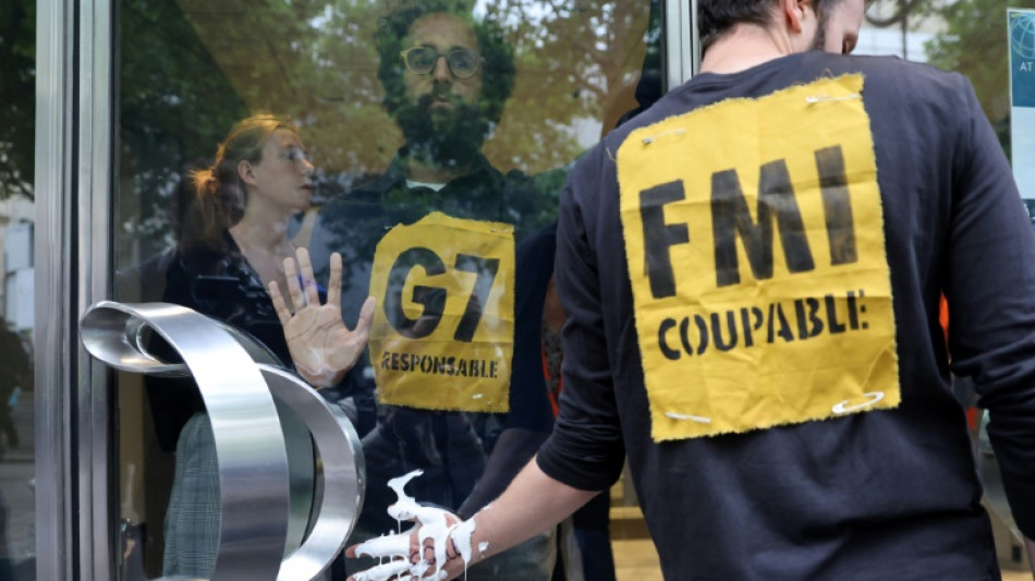 Climate activists block IMF Paris office doors